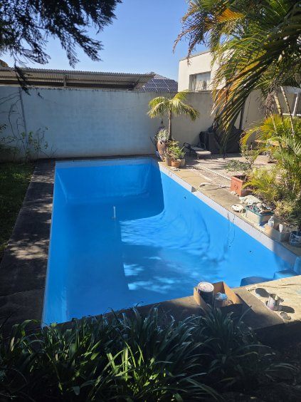 A backyard swimming pool with a fresh coat of blue