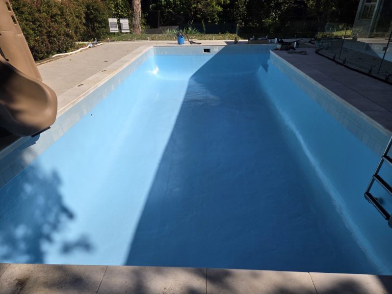The same pool with a full, even coat of blue paint